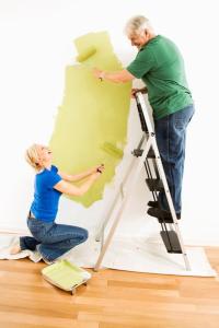 man and woman painting wall